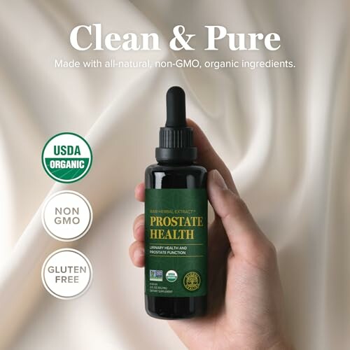 Hand holding a bottle of organic prostate health supplement with USDA Organic, Non-GMO, and Gluten Free labels.